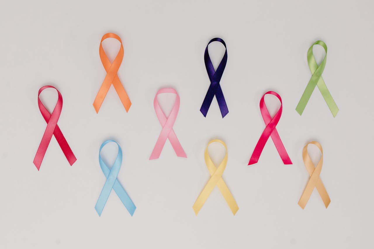 A collection of colorful awareness ribbons symbolizing various causes on a white background.